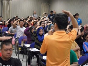 Trainer guide 100 participants to perform calming together